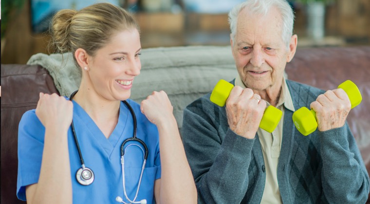 a health care professional helping a man use barbells